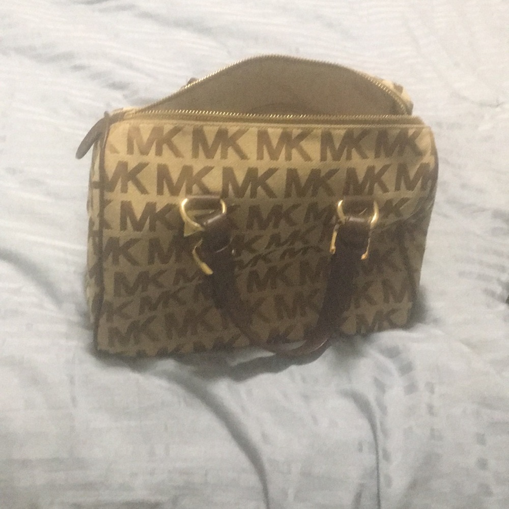 A Michael Kors purse which is brown